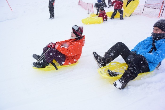 Our staffers enjoying the sled