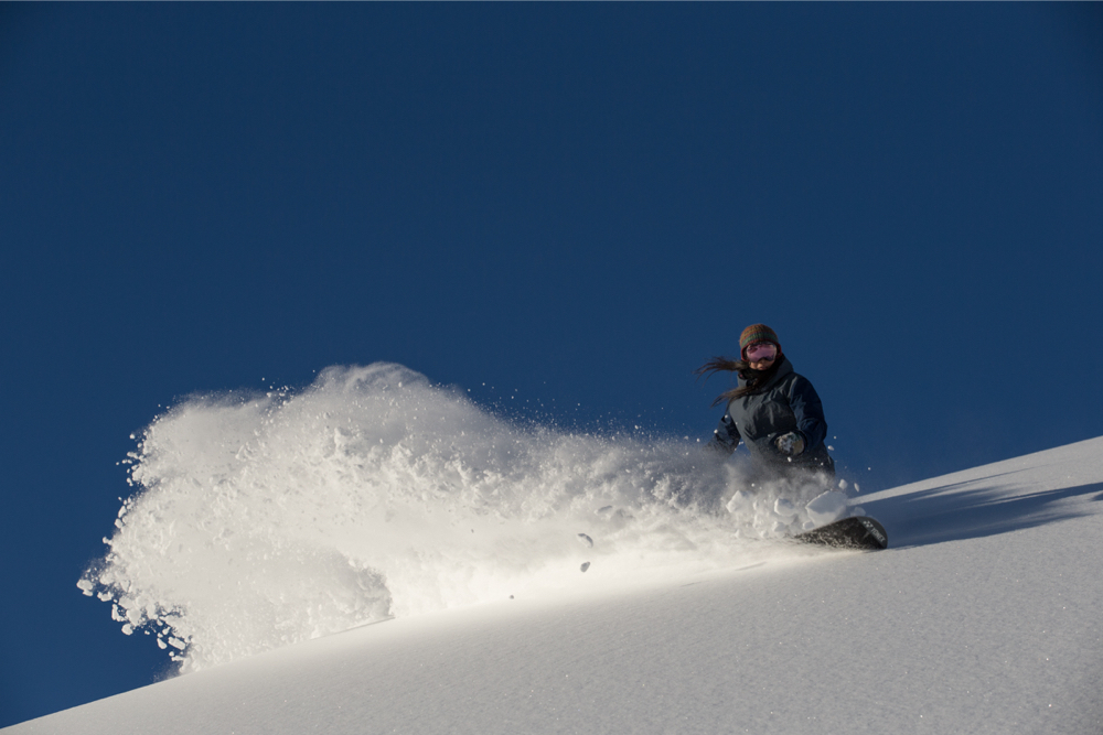 A snowboarder in the non-compacted snow zone